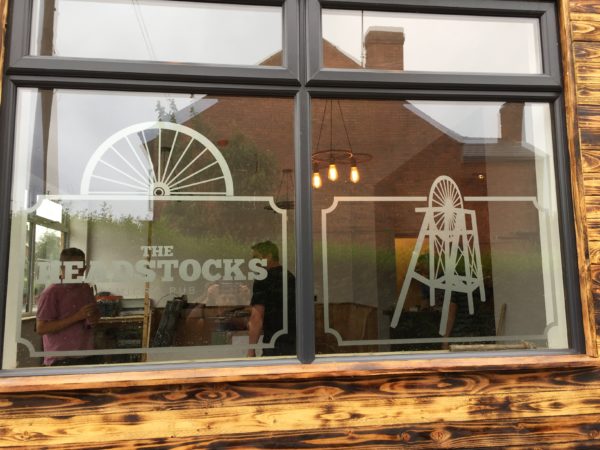 Etched-effect window graphics with penny farthing motifs fitted at the Headstocks micro pub