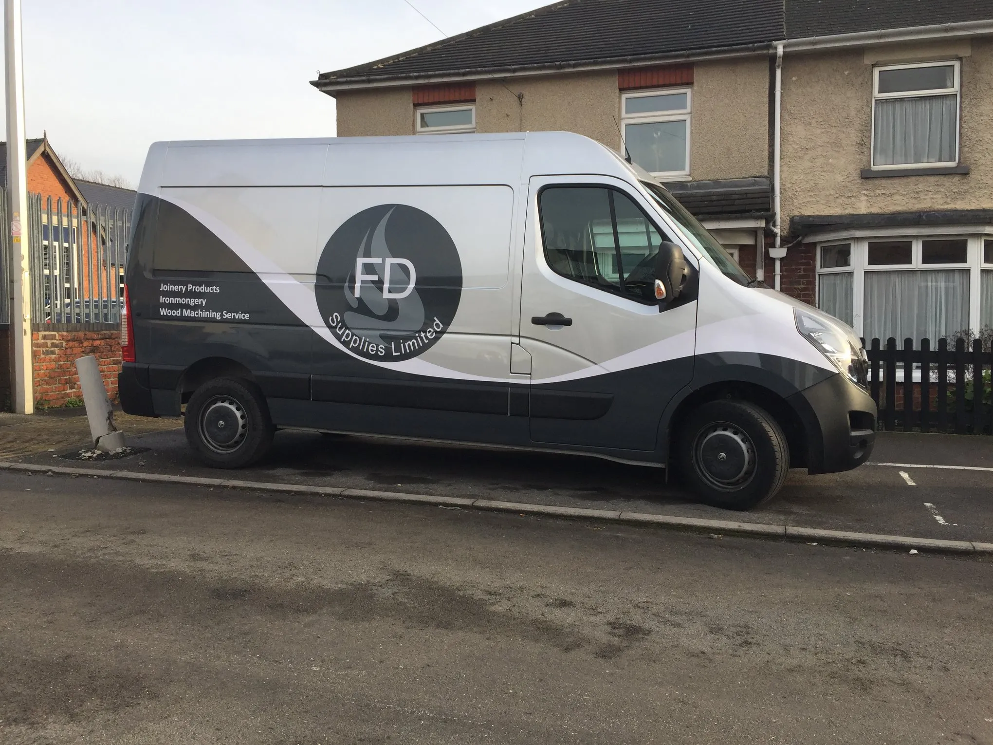 FD Supplies branded van with full vinyl wrap parked on residential street