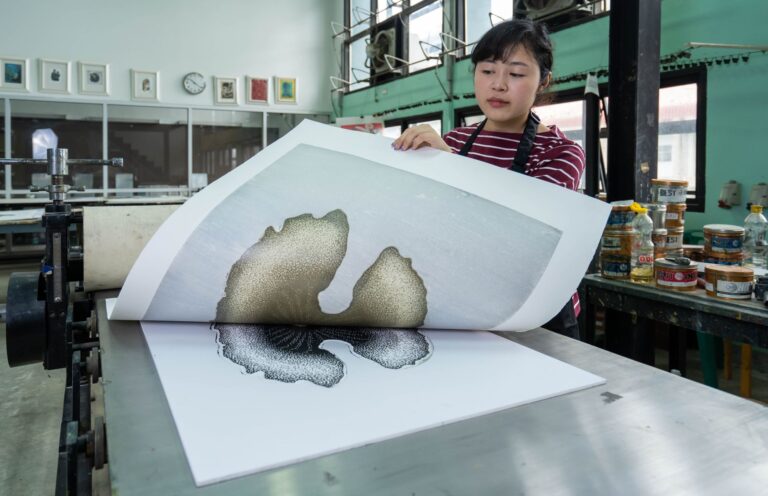 Wide-format banners and posters being produced in a professional large format print studio