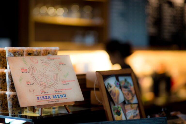 Menu printing for hospitality: a printed pizza menu card displayed on a cafe counter