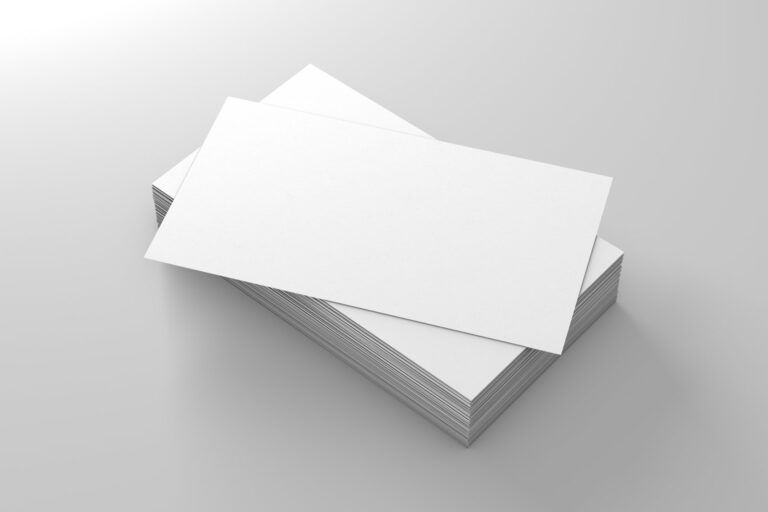 Business stationery printing: a stack of blank printed business cards on a plain surface