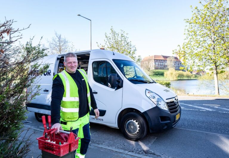 Chapter 8 chevrons guide: contractor in hi-vis workwear standing beside a works van